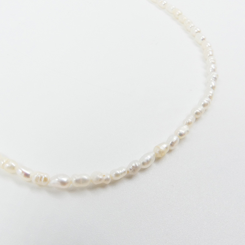 Collier acier doré perles d’eau douce