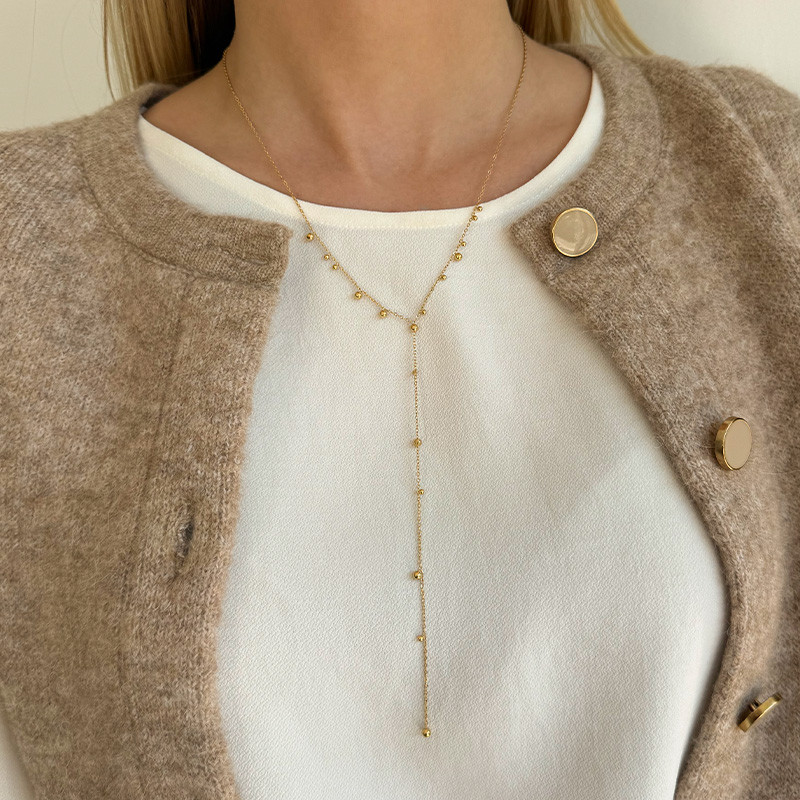 Collier cravate acier doré boule